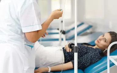 медсестра ставит женщине капельницу
